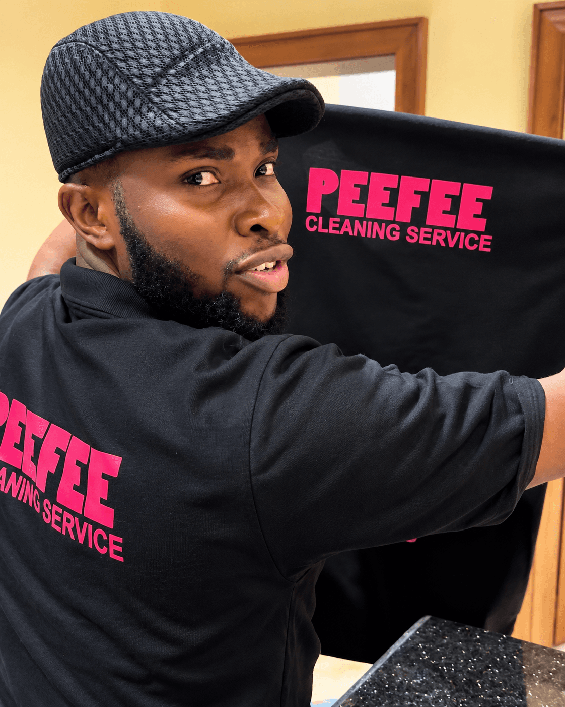 PeeFee 101 Services CEO holding the company uniform